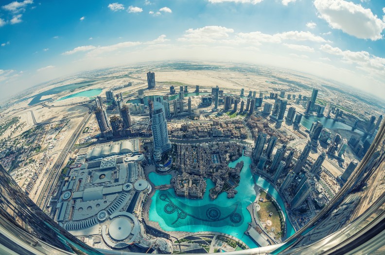 A British expatriate seeing the Dubai skyline from an aeroplane prior to landing in the United Arab Emirates for corporate relocation