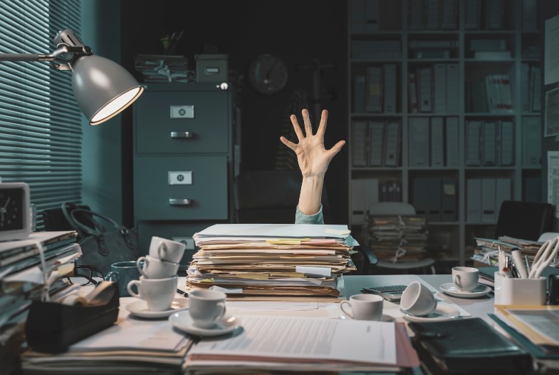 A stressed office worker trying to sort out the paperwork for his relocation to Netherlands