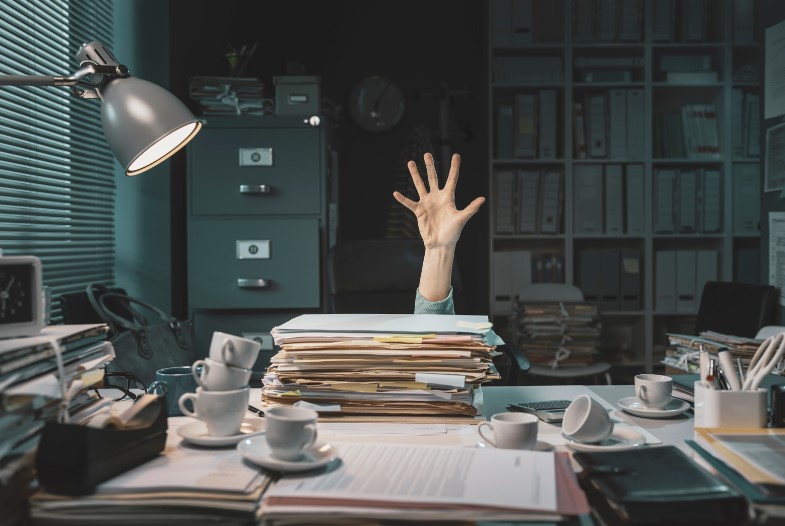 A stressed office worker trying to sort out the paperwork for his relocation to Netherlands 