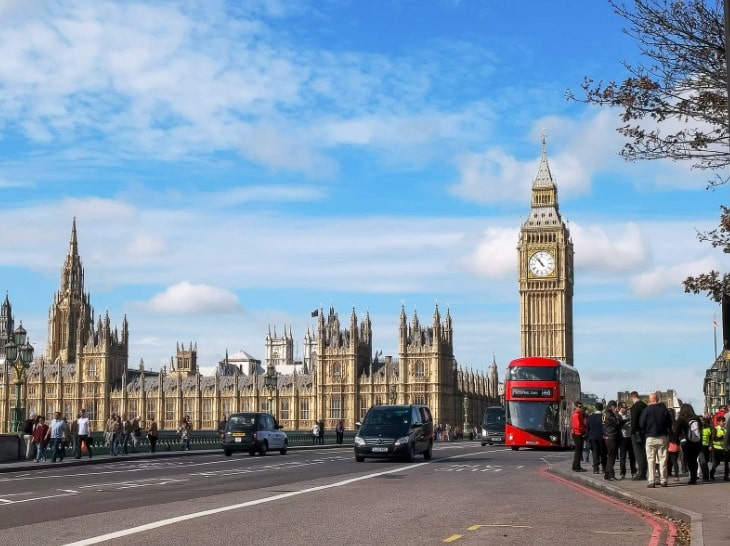 A small black car driving on a road in Central London after being imported by a EU expatriate